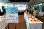 Attendees networking by the breakfast table before the program